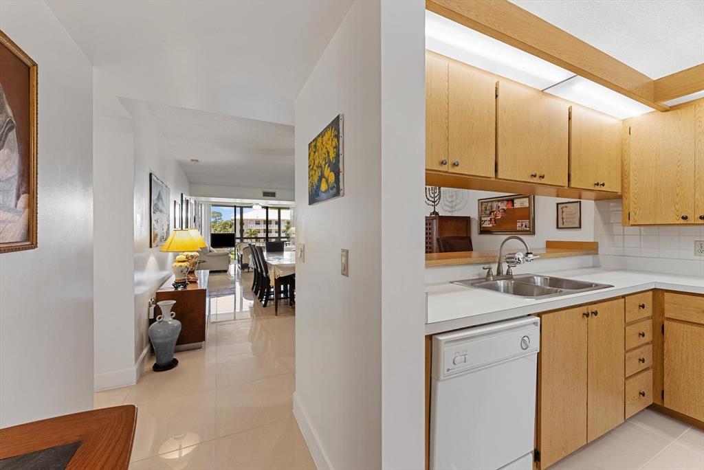 6217 Balboa Circle, Unit 305 Boca Raton, FL 33433 - Photo 5 of 28 a kitchen with sink cabinets and utility