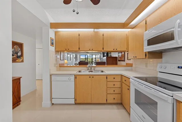 a view of a dining room with furniture and a ceiling fan