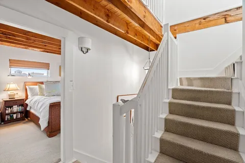 a view of staircase with white walls and stairs