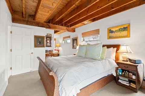 a bedroom with bed and wooden furniture