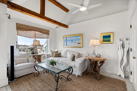 a living room with furniture a rug and a table