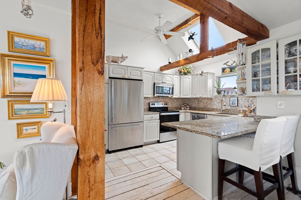 10 61st Street, Unit 10 Newburyport, MA 01950 - Photo 33 of 42 a kitchen with stainless steel appliances granite countertop a stove and a refrigerator