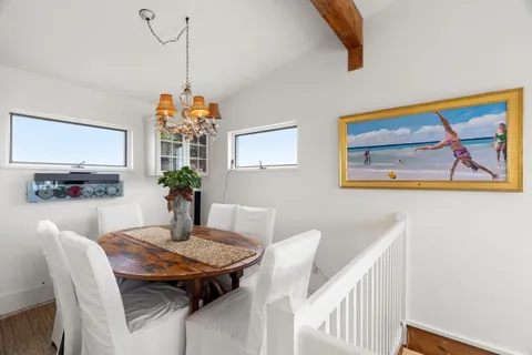 a dining room with furniture and window