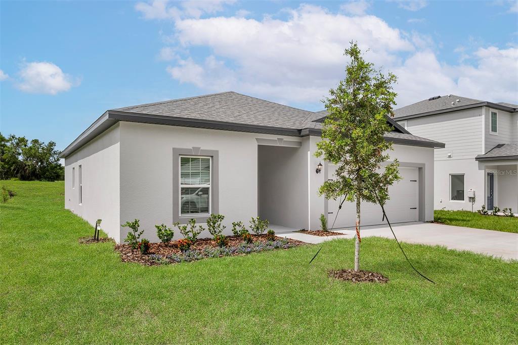 13352 Tula Loop Astatula, FL 34705 - Photo 2 of 19 a view of a backyard with a garden