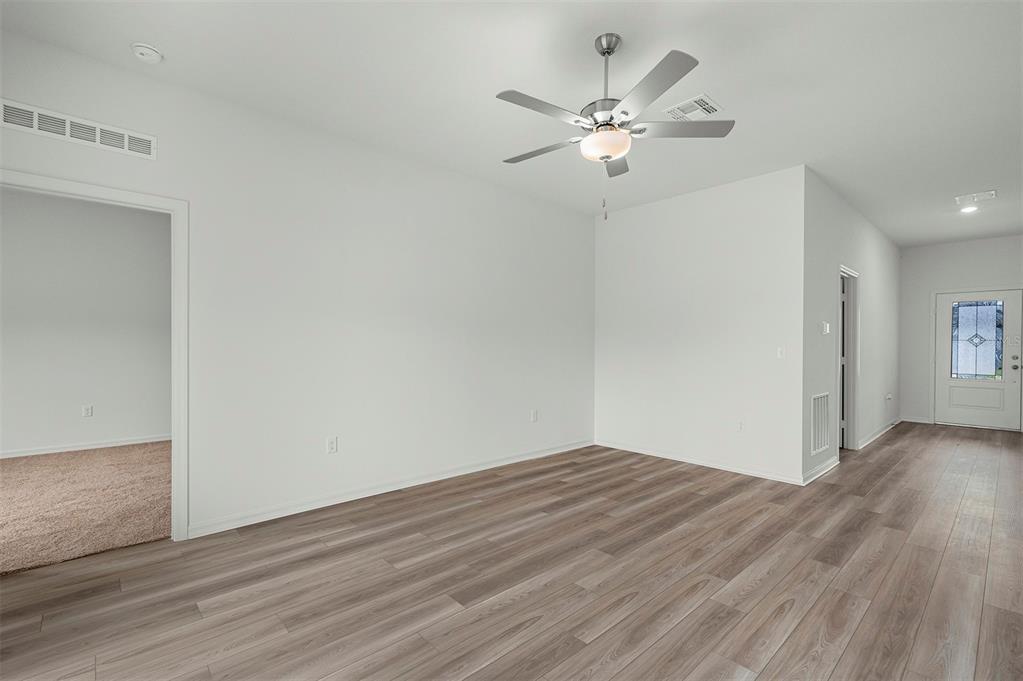 13352 Tula Loop Astatula, FL 34705 - Photo 7 of 19 a view of an empty room with wooden floor