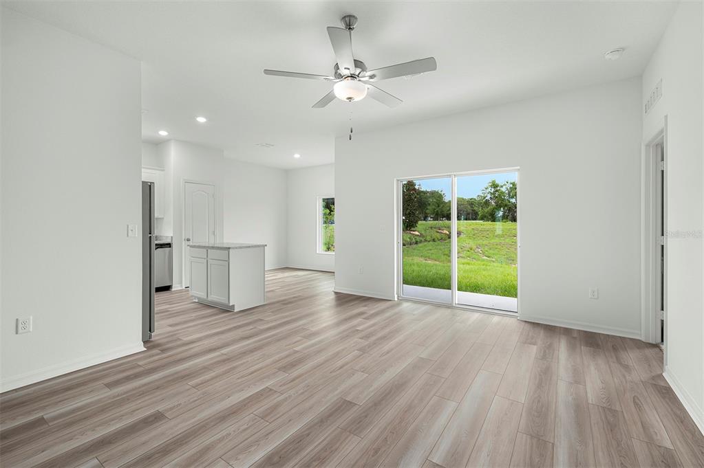 13352 Tula Loop Astatula, FL 34705 - Photo 8 of 19 a view of an empty room with wooden floor and a window