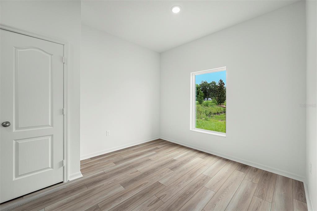 13352 Tula Loop Astatula, FL 34705 - Photo 9 of 19 an empty room with wooden floor and window