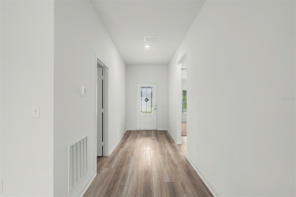 13352 Tula Loop Astatula, FL 34705 - Photo 10 of 19 a view of a hallway with wooden floor