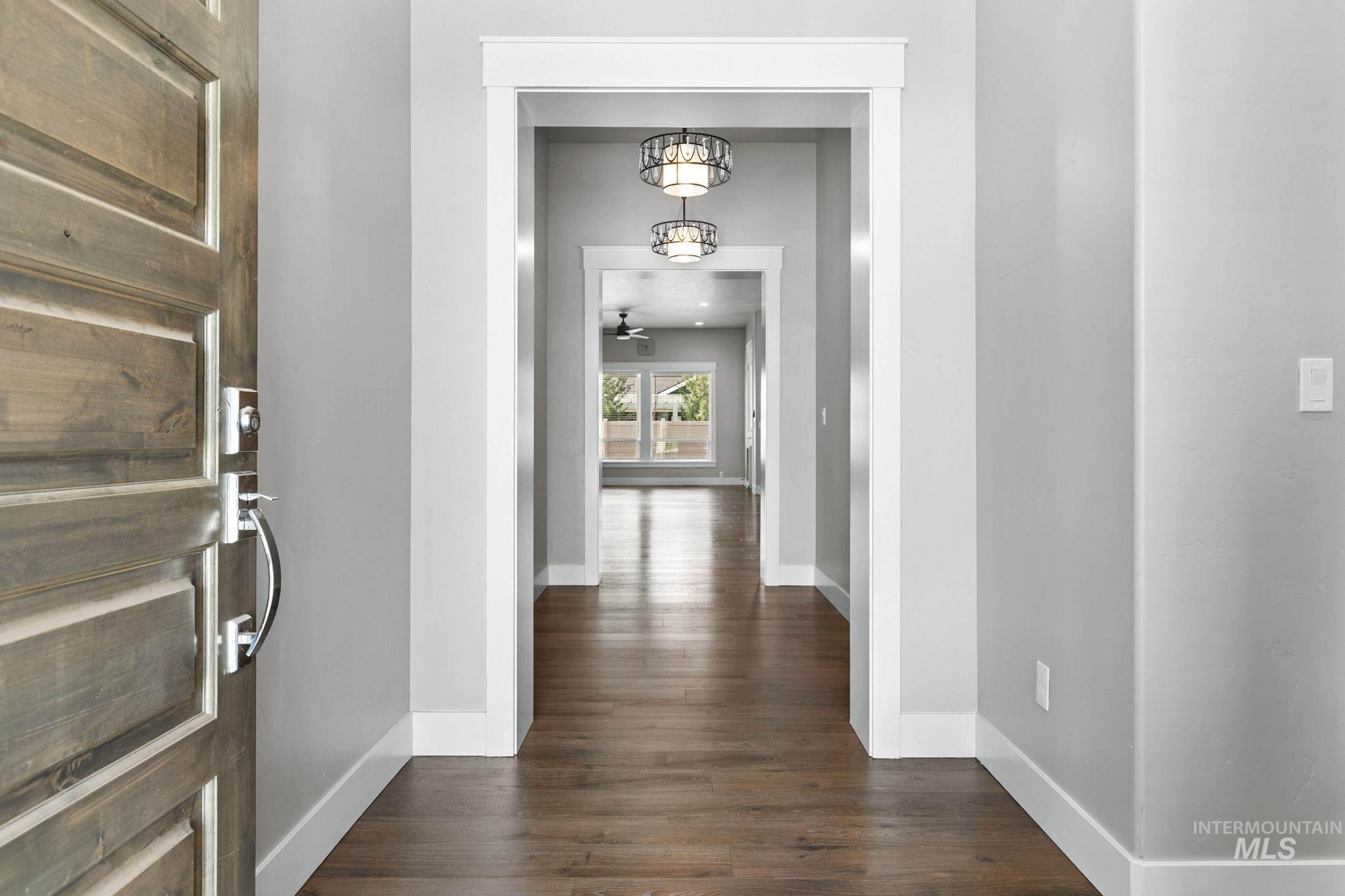 2934 East Murchison Street Meridian, ID 83642 - Photo 5 of 44 Entryway featuring a wood-panel door with polished chrome hardware, hardwood flooring, neutral wall tones, and recessed lighting