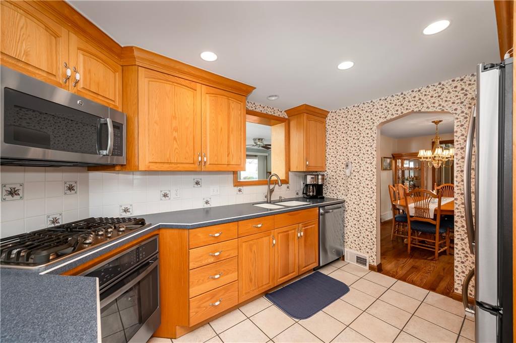 502 Nichols Road Pittsburgh, PA 15237 - Photo 12 of 46 a kitchen with stainless steel appliances granite countertop a stove a sink and a microwave
