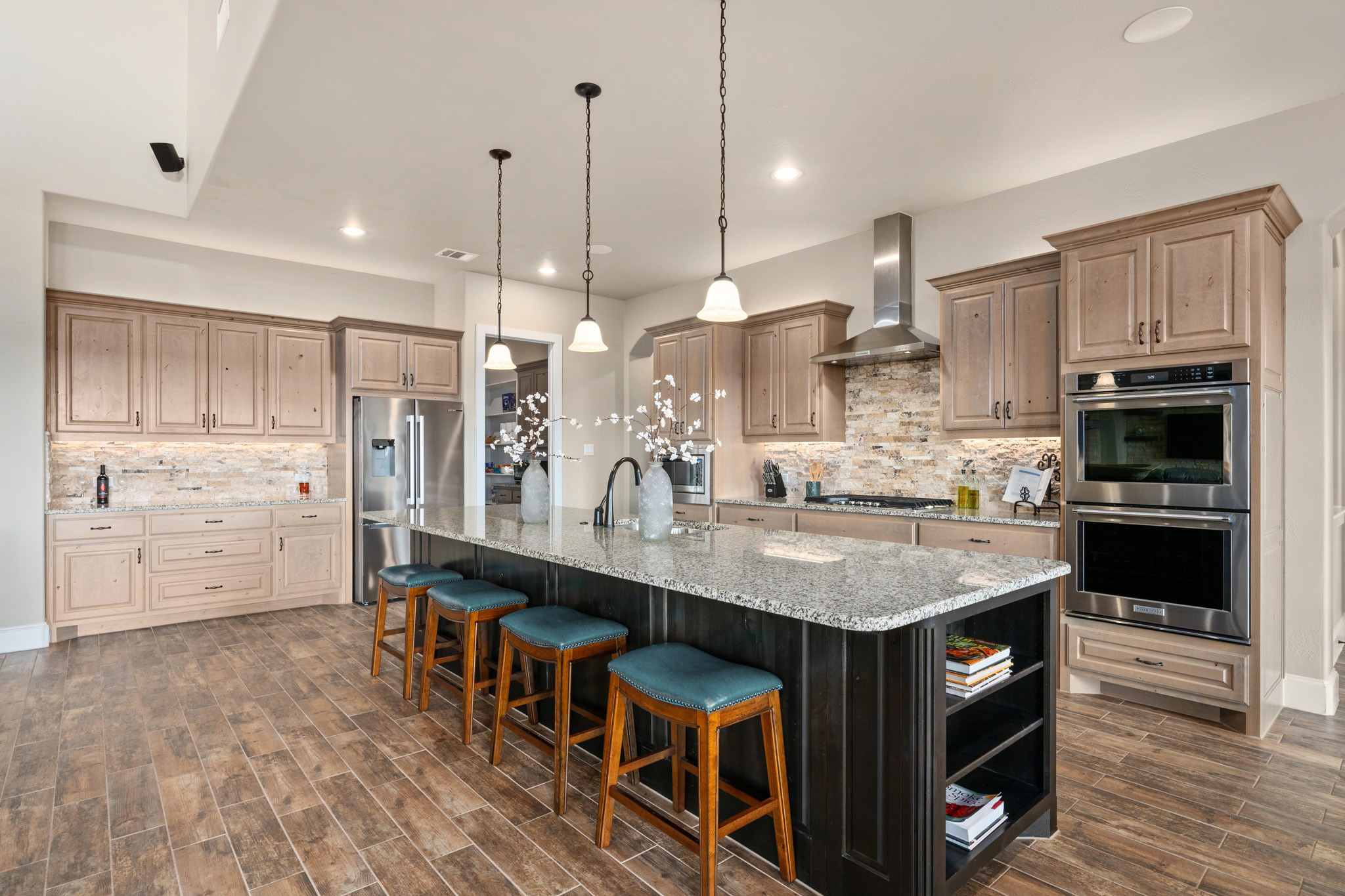 204 Wilderness Trail Georgetown, TX 78633 - Photo 15 of 38 a kitchen with stainless steel appliances granite countertop a table chairs sink and cabinets