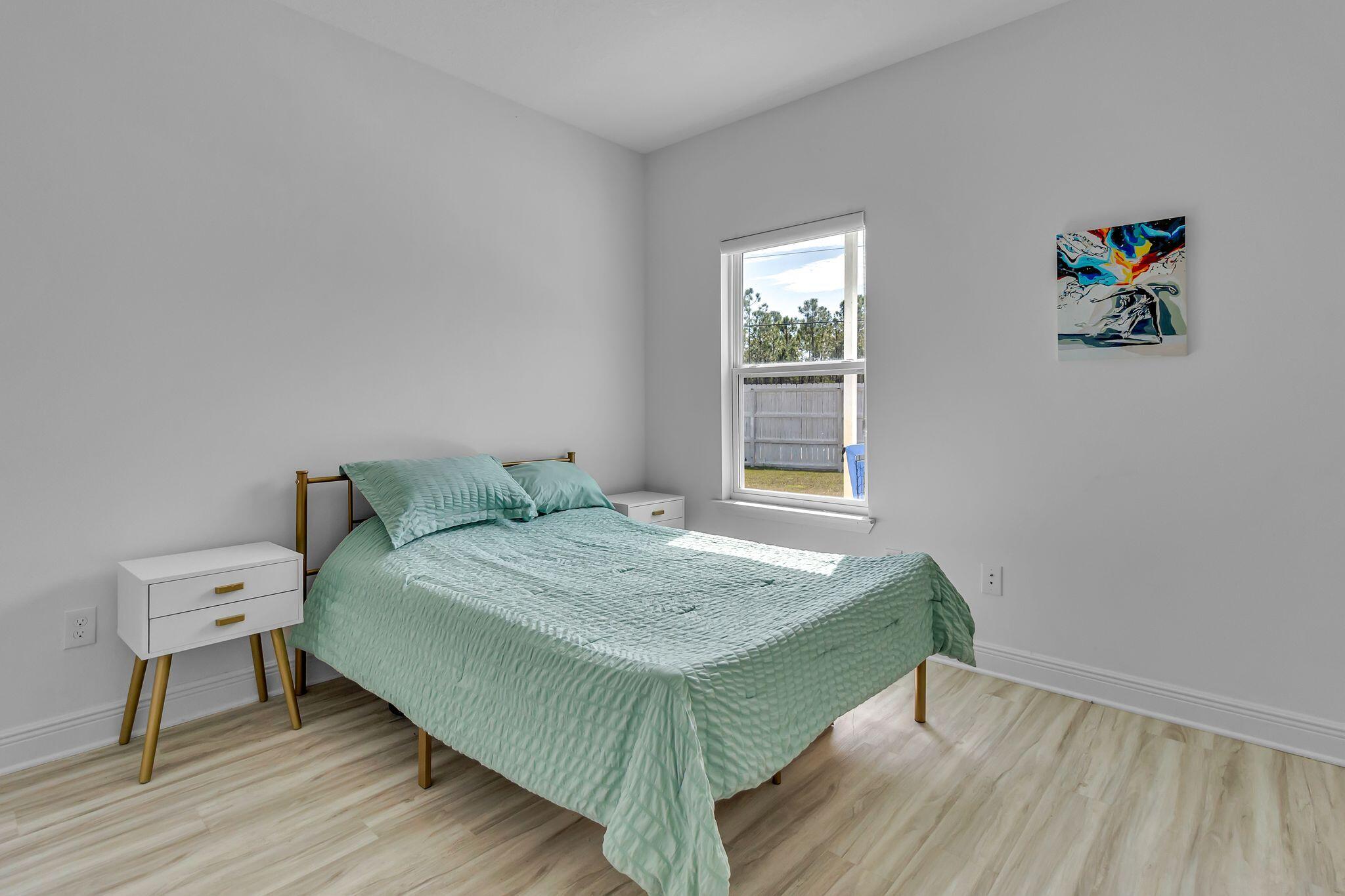 77 Spoonbill Road, Unit LOT 66 Santa Rosa Beach, FL 32459 - Photo 13 of 48 a bedroom with a bed and a table in it