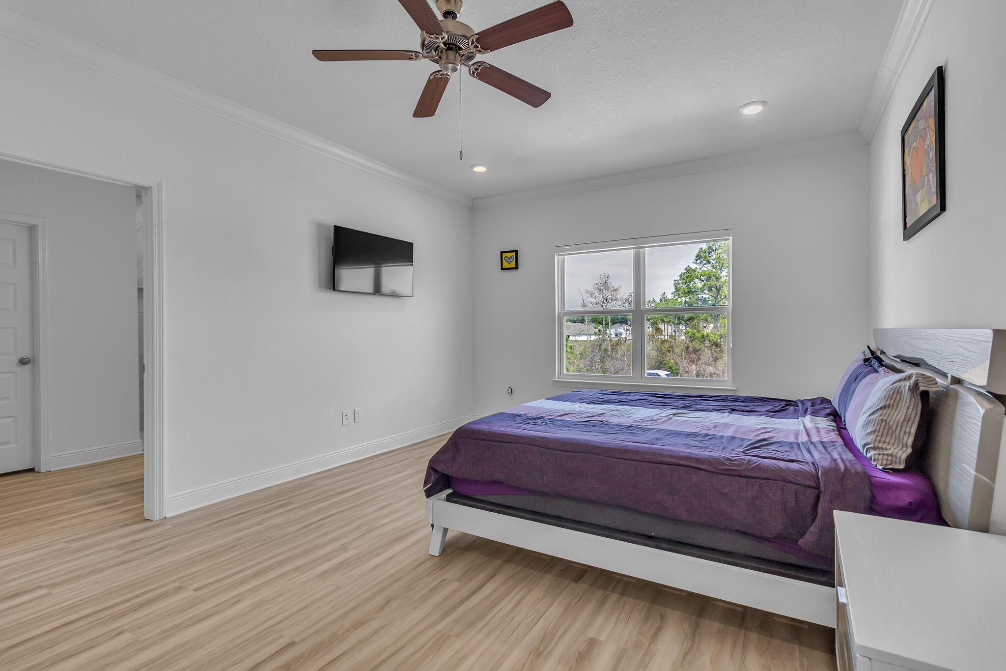 77 Spoonbill Road, Unit LOT 66 Santa Rosa Beach, FL 32459 - Photo 16 of 48 a bed sitting in a bedroom next to a window