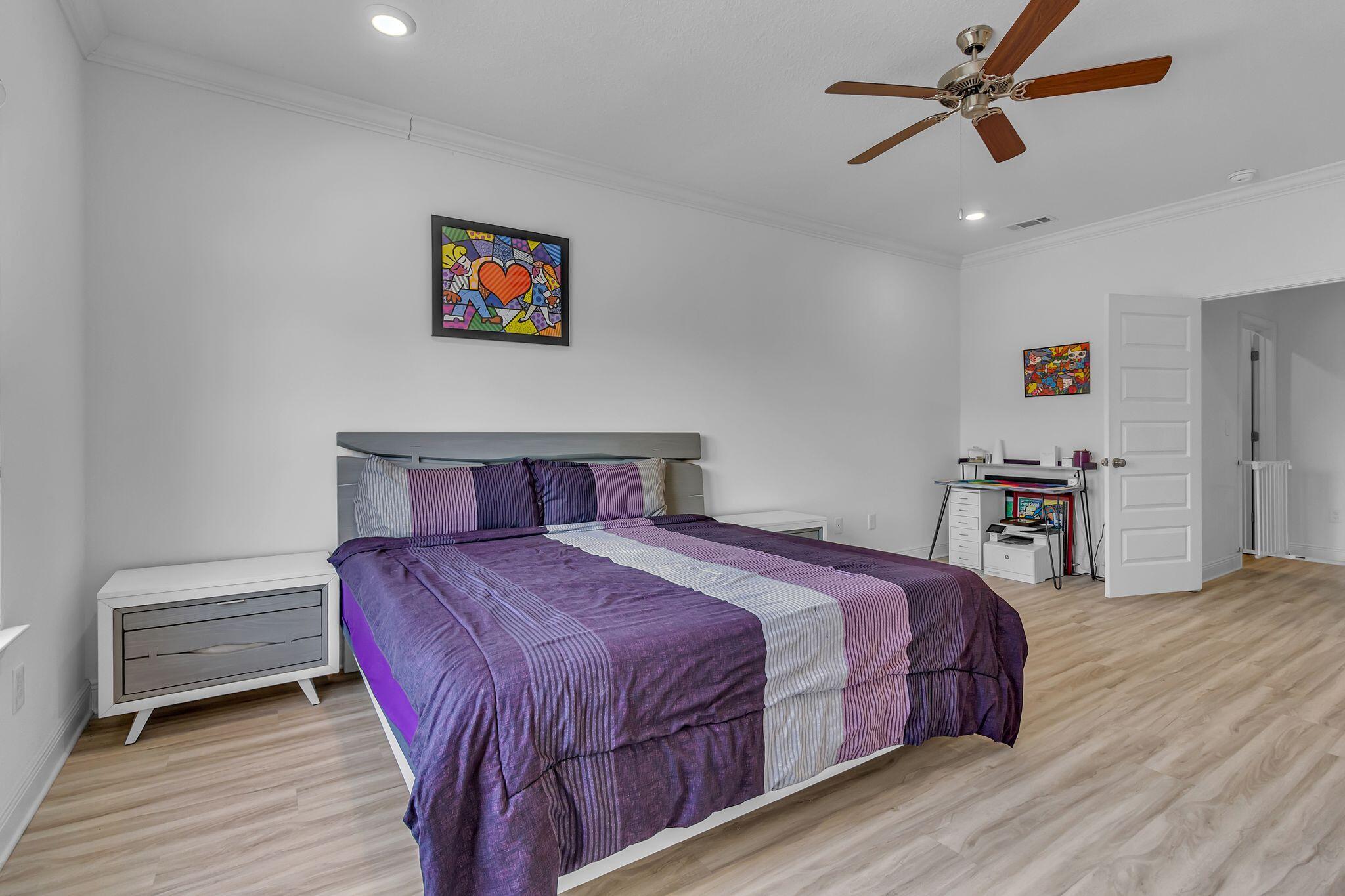 77 Spoonbill Road, Unit LOT 66 Santa Rosa Beach, FL 32459 - Photo 17 of 48 a bedroom with a bed a dresser and wooden floor