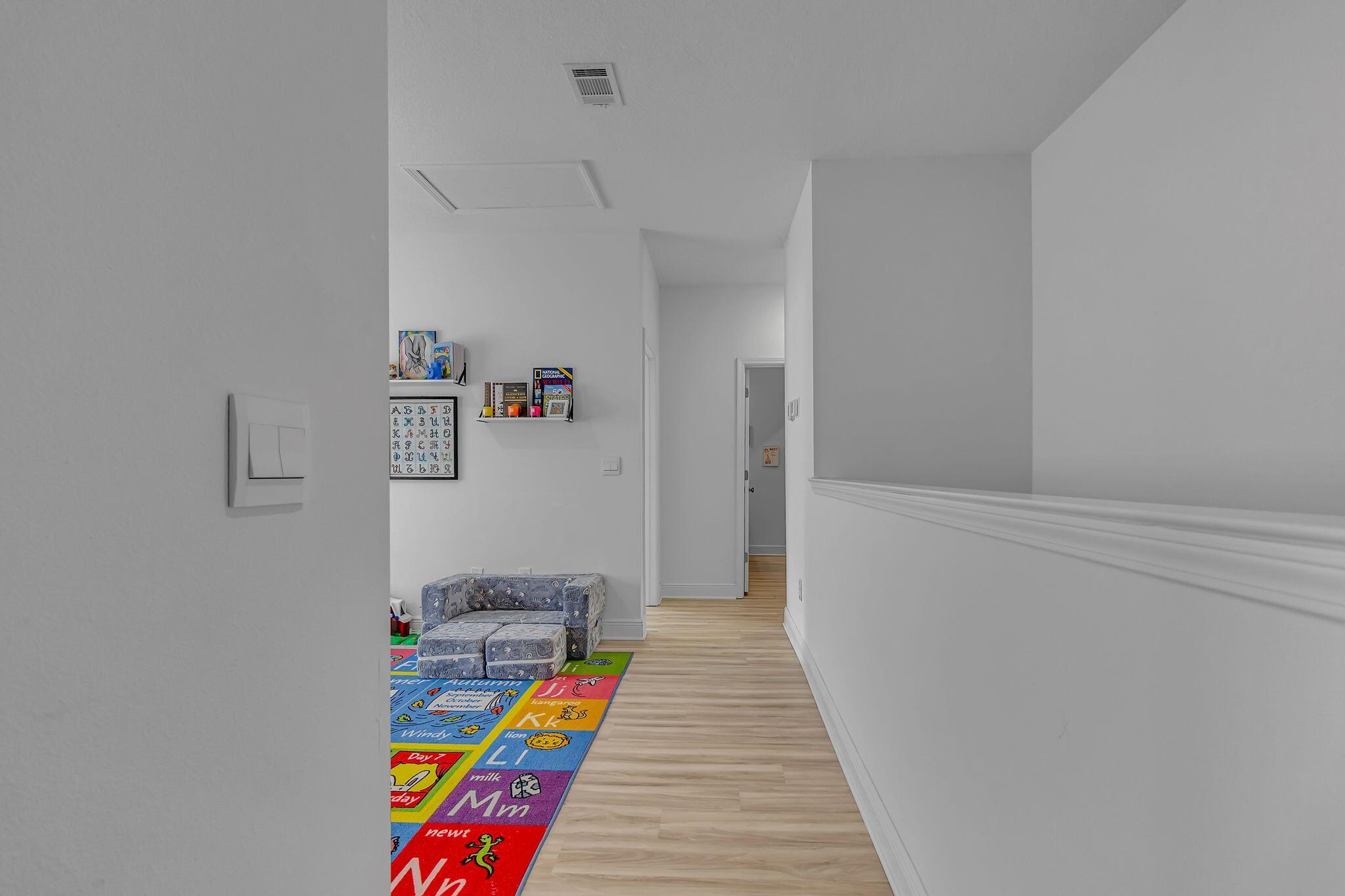 77 Spoonbill Road, Unit LOT 66 Santa Rosa Beach, FL 32459 - Photo 21 of 48 a hallway with toys and wooden floor