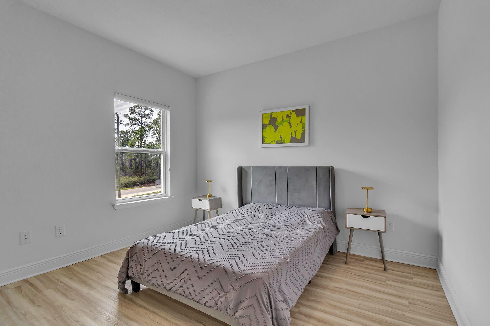 77 Spoonbill Road, Unit LOT 66 Santa Rosa Beach, FL 32459 - Photo 25 of 48 a bedroom with a bed and painting on the wall