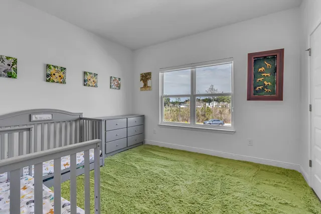 a view of an empty room with window and stairs