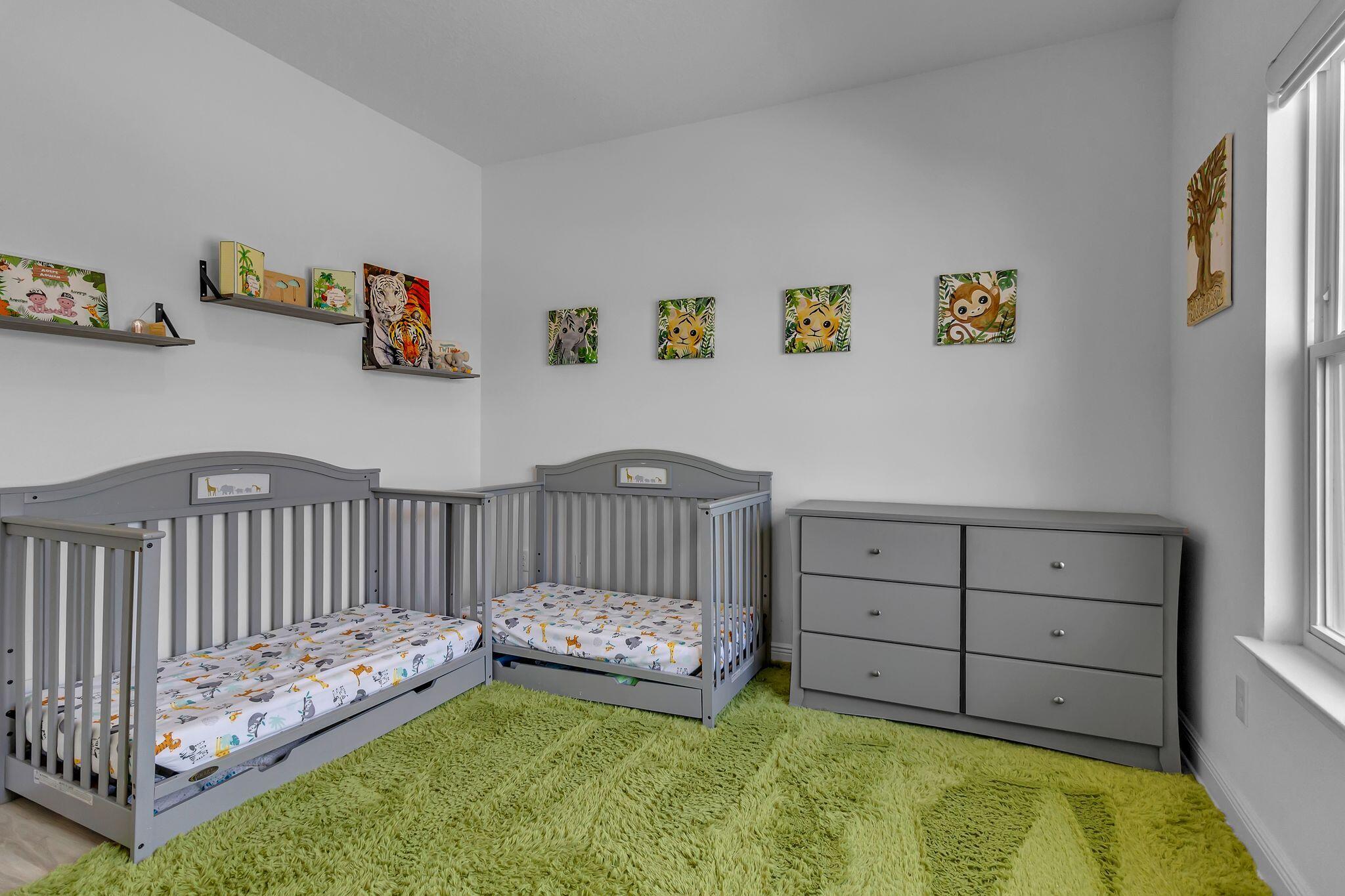 77 Spoonbill Road, Unit LOT 66 Santa Rosa Beach, FL 32459 - Photo 30 of 48 a view of a bedroom with baby crib and lounge chair