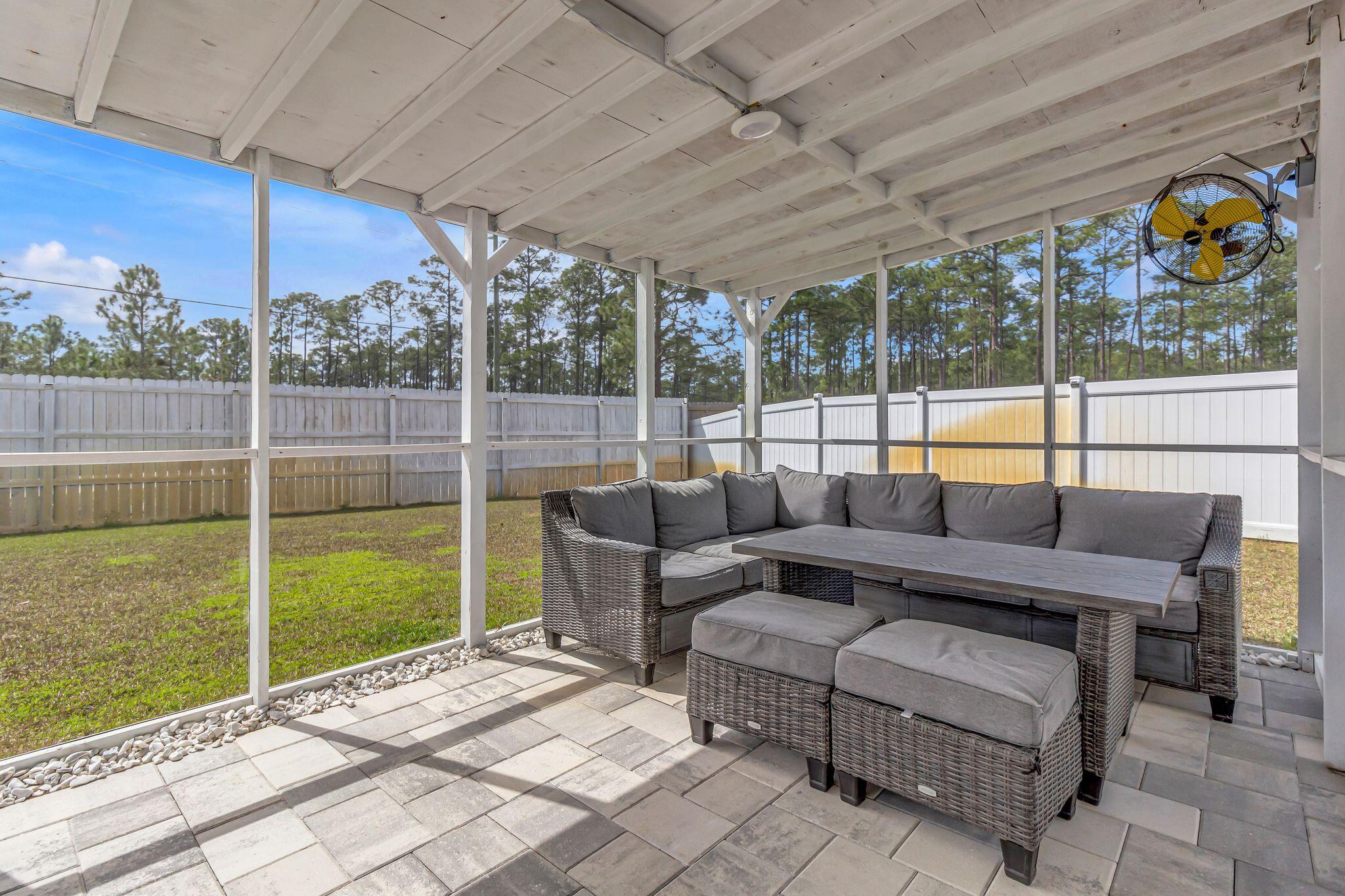 77 Spoonbill Road, Unit LOT 66 Santa Rosa Beach, FL 32459 - Photo 32 of 48 a outdoor living space with furniture and garden view