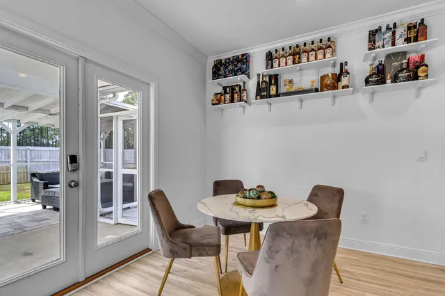 a view of a dining room with furniture wooden floor and next to a window