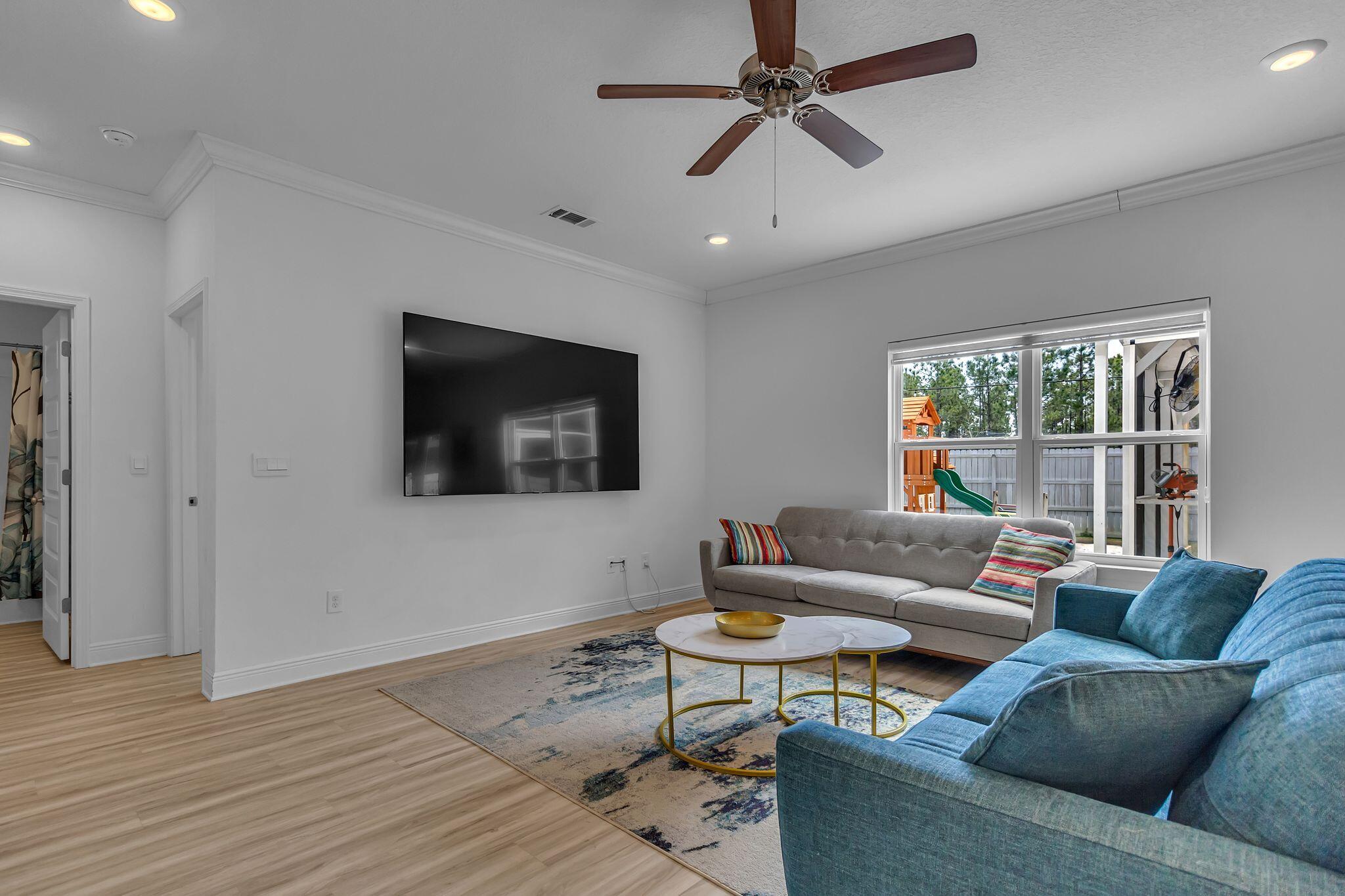 77 Spoonbill Road, Unit LOT 66 Santa Rosa Beach, FL 32459 - Photo 10 of 48 a living room with furniture and a flat screen tv