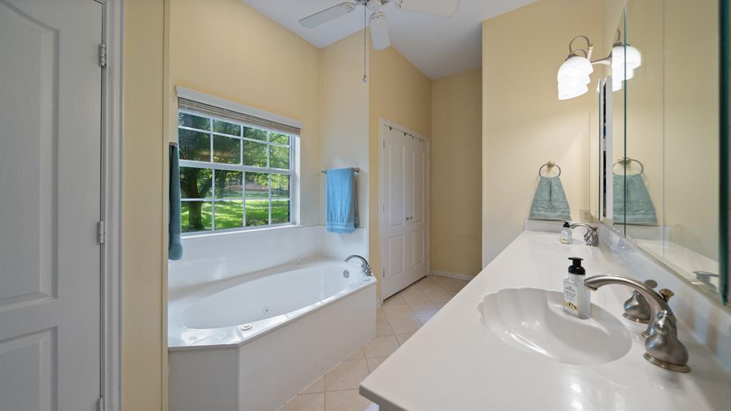 875 Arnold Paul Road Canton, TX 75103 - Photo 16 of 32 a bathroom with a tub sink and mirror