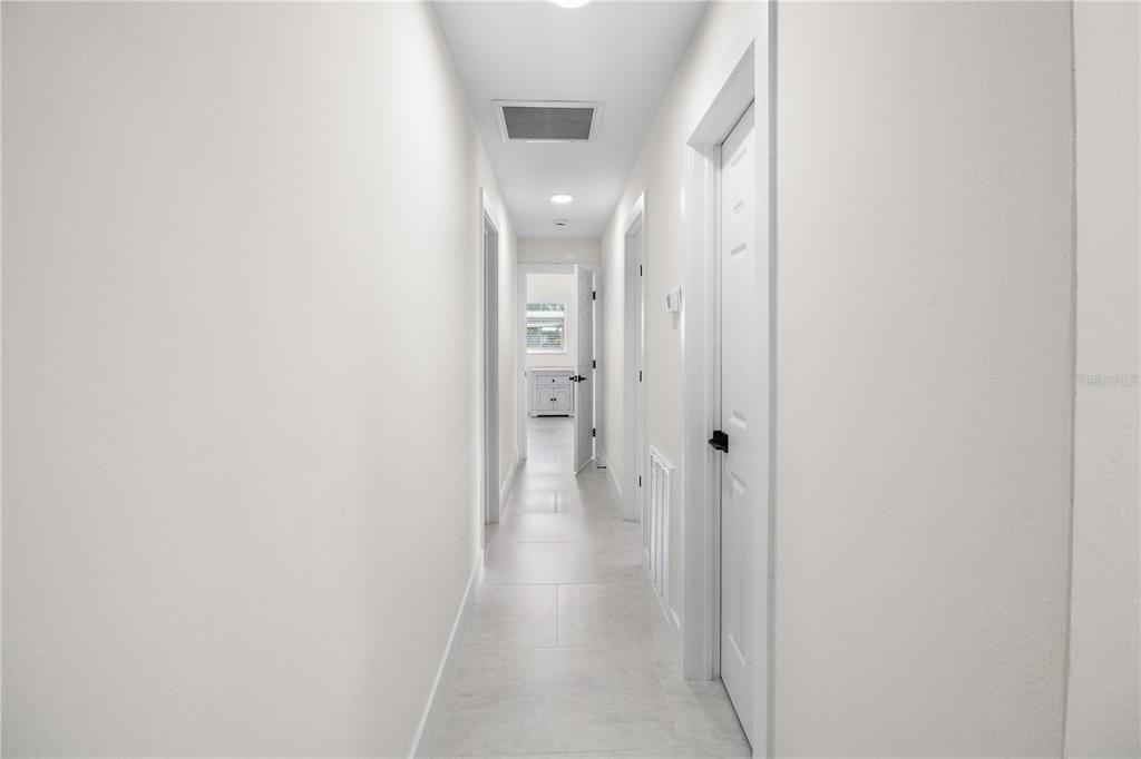 1575 Brookside Boulevard Largo, FL 33770 - Photo 17 of 42 a view of a hallway with wooden floor