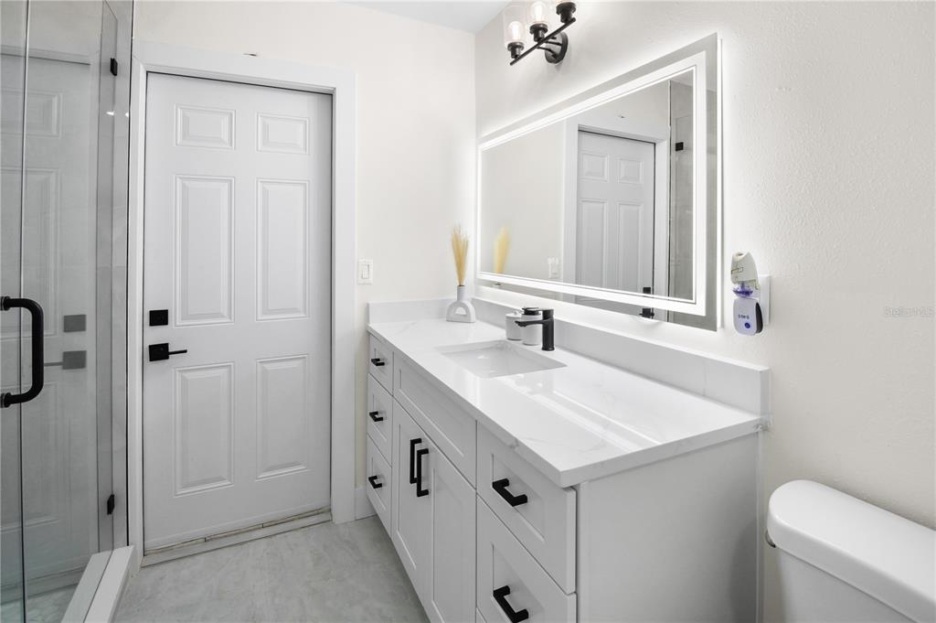 1575 Brookside Boulevard Largo, FL 33770 - Photo 18 of 42 a bathroom with a sink a toilet and shower