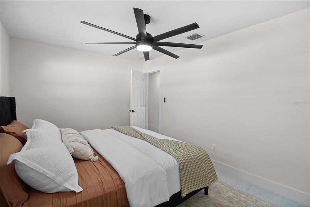 1575 Brookside Boulevard Largo, FL 33770 - Photo 23 of 42 a bedroom with a bed and a ceiling fan
