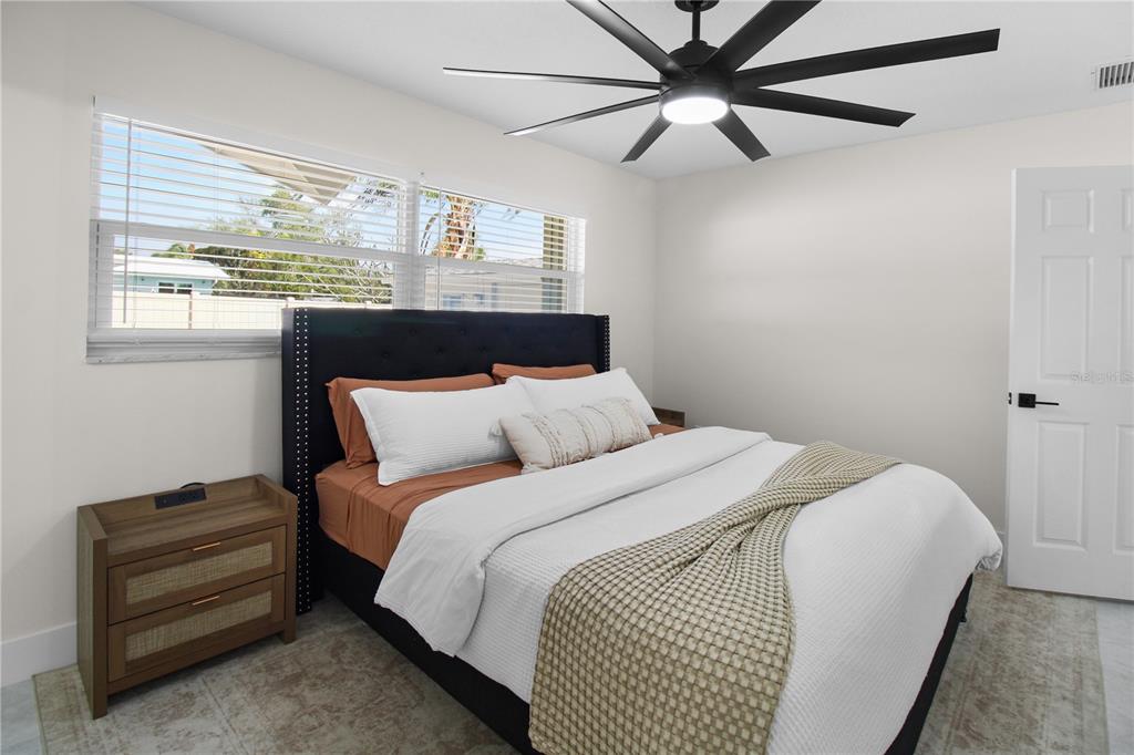 1575 Brookside Boulevard Largo, FL 33770 - Photo 24 of 42 a bed sitting in a bedroom next to a window