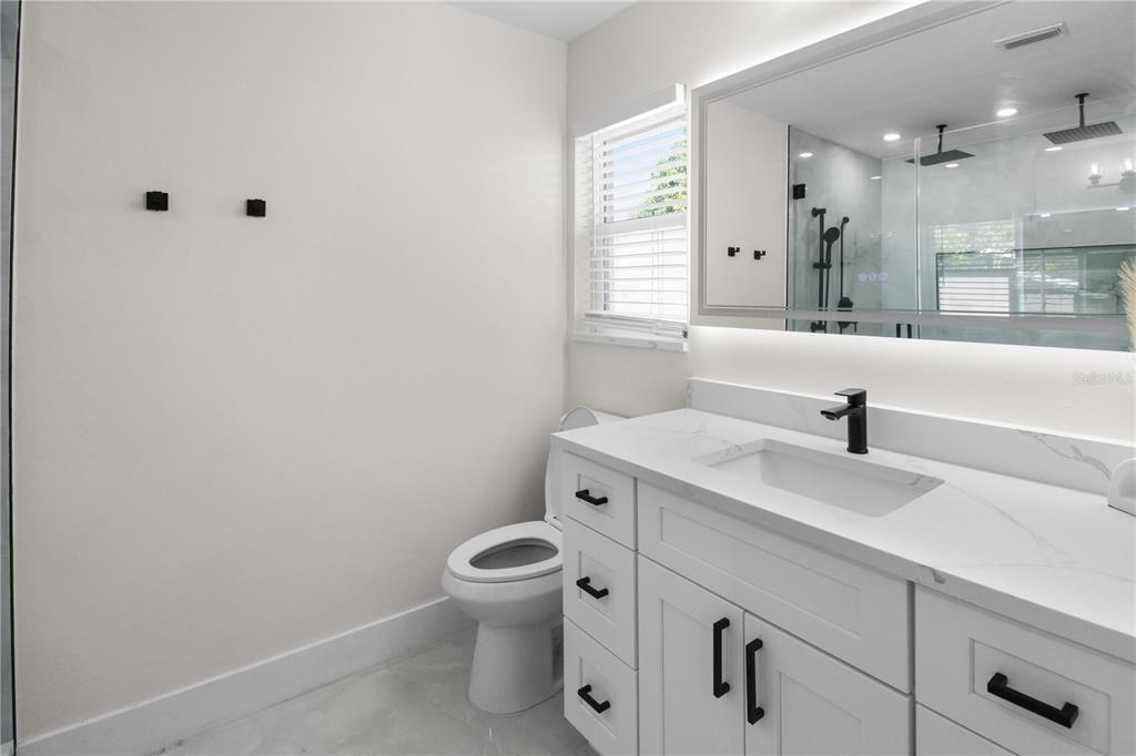 1575 Brookside Boulevard Largo, FL 33770 - Photo 29 of 42 a bathroom with a sink mirror vanity and toilet