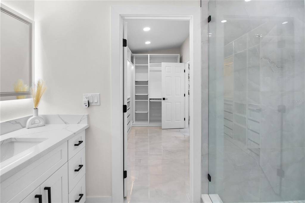 1575 Brookside Boulevard Largo, FL 33770 - Photo 31 of 42 a bathroom with a sink shower and a mirror