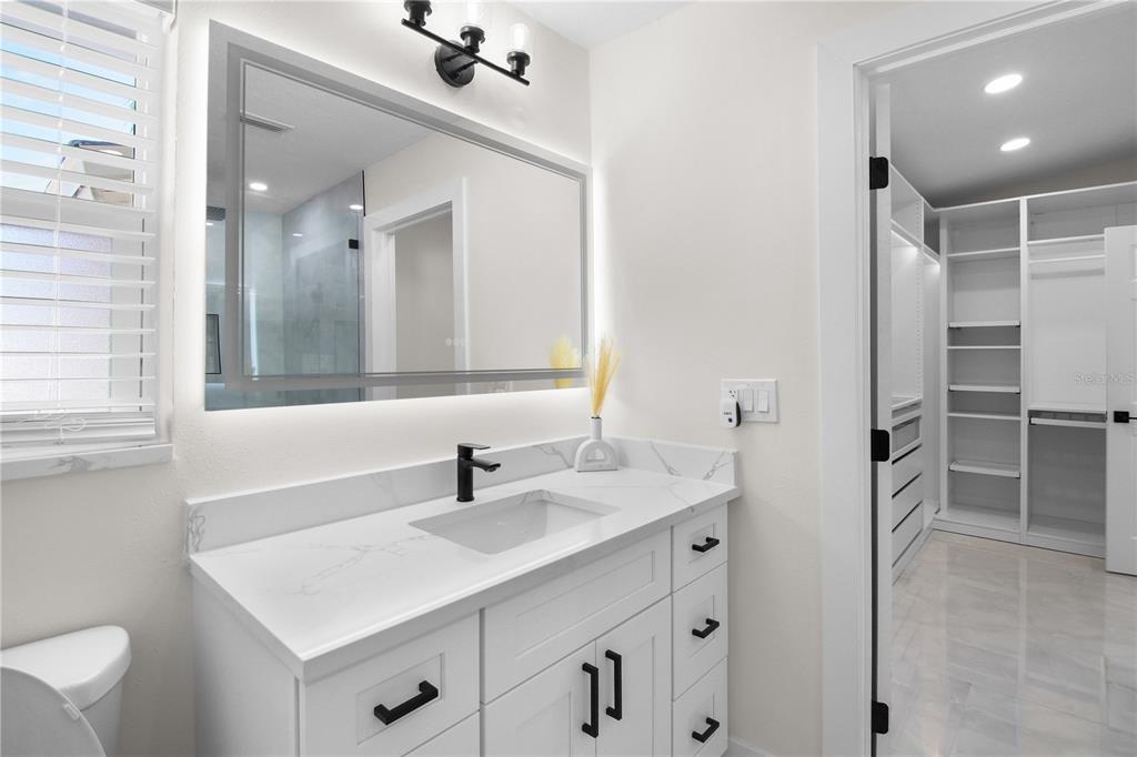 1575 Brookside Boulevard Largo, FL 33770 - Photo 32 of 42 a bathroom with a sink vanity and a mirror