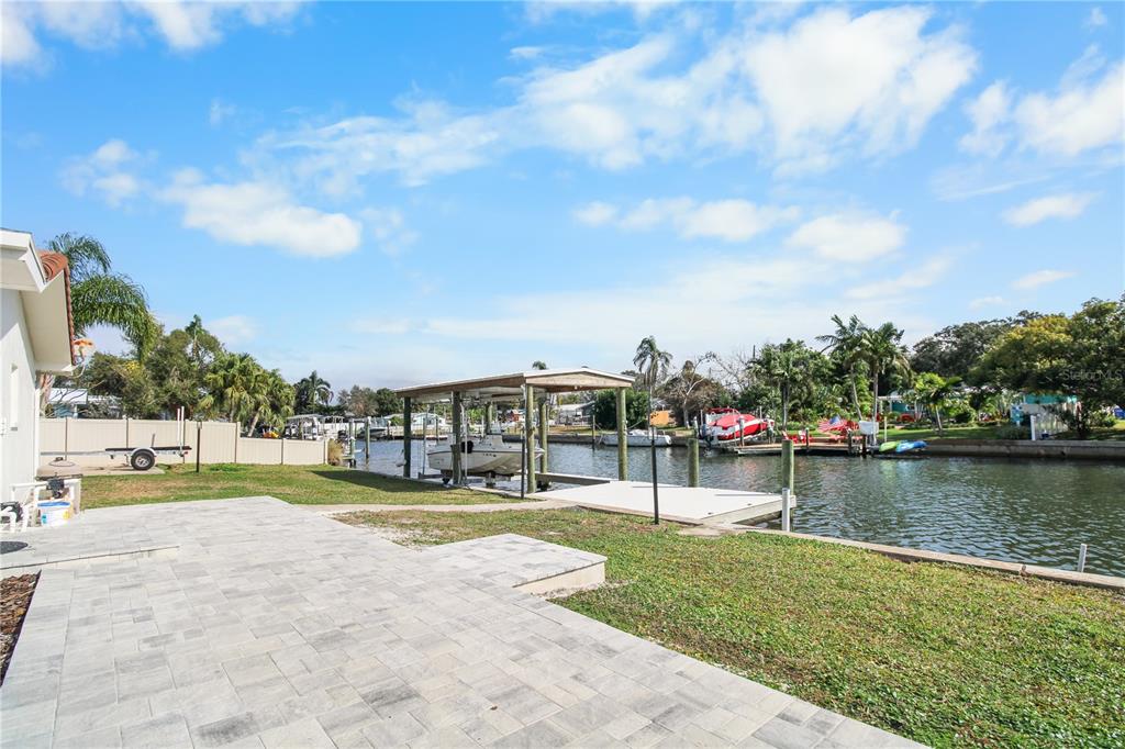 1575 Brookside Boulevard Largo, FL 33770 - Photo 38 of 42 a view of a swimming pool with a patio and a yard