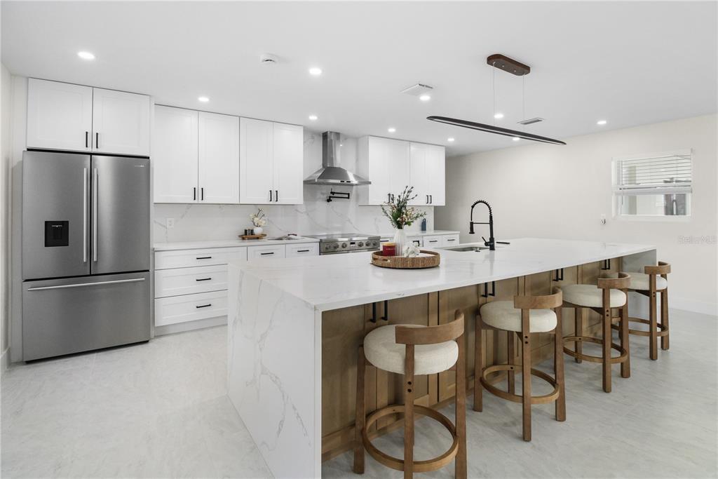 1575 Brookside Boulevard Largo, FL 33770 - Photo 7 of 42 a kitchen with a sink a refrigerator and white cabinets