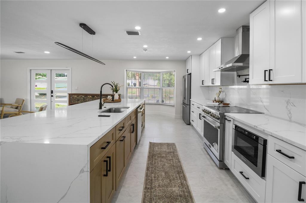 1575 Brookside Boulevard Largo, FL 33770 - Photo 9 of 42 a kitchen with stainless steel appliances granite countertop a sink and stove