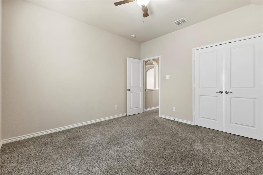 6522 Portside Ridge Lane Dallas, TX 75249 - Photo 25 of 37 Carpeted room featuring neutral wall tones, white trim, and a ceiling fan with integrated lighting