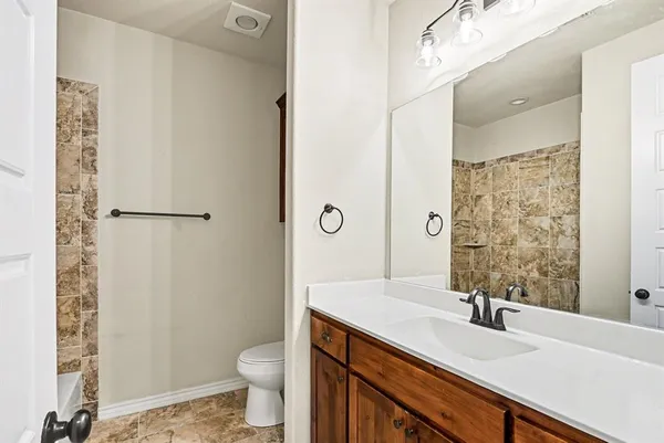 a large kitchen with kitchen island white cabinets and stainless steel appliances