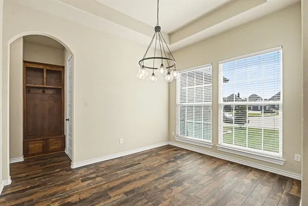 a large kitchen with cabinets wooden floor and stainless steel appliances