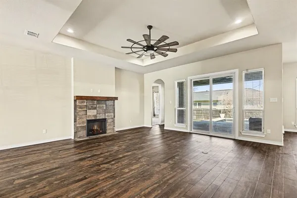 a view of wooden floor and window in a room