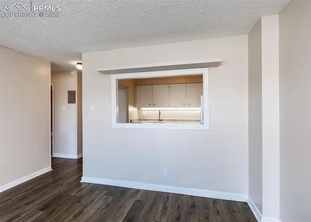 a kitchen with granite countertop white cabinets and white appliances