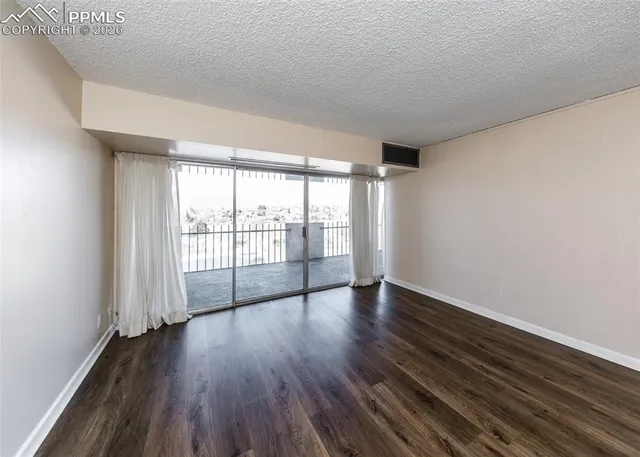 a view of an empty room and wooden floor