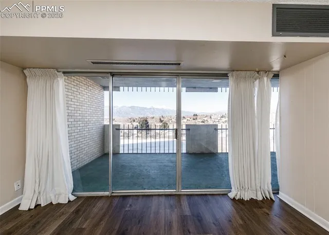 a view of a room with wooden floor and sink
