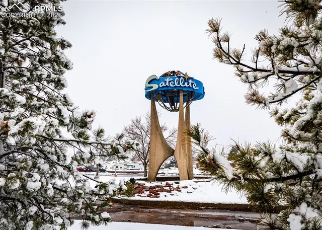 a living room with furniture and large windows