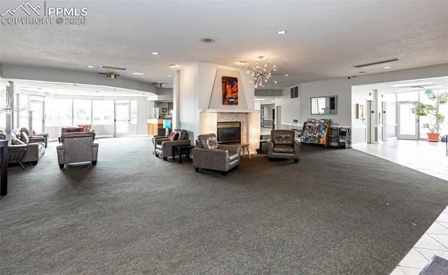a view of a porch with chairs and a potted plant
