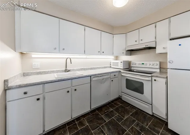 a kitchen with a sink and cabinets