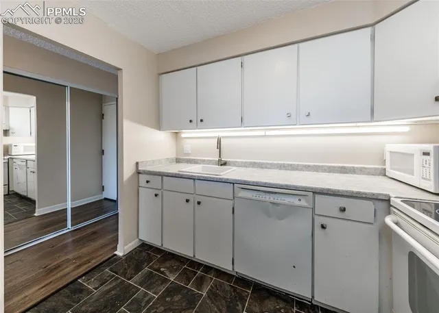 a view of a hallway with wooden floor and closet area