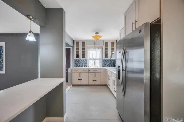 a kitchen with stainless steel appliances a refrigerator sink and cabinets