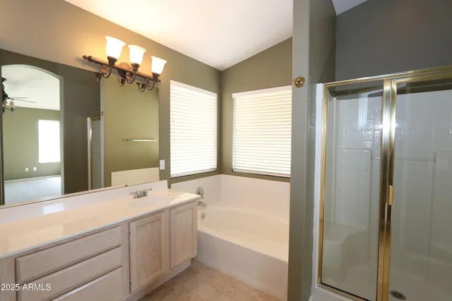 a bathroom with a tub sink and mirror