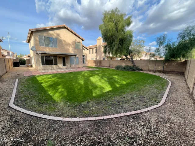 a view of a house with a backyard